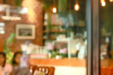 abstract blur of interior inside coffee cafe shop background with light effect for design element. Blurred cafe background with bokeh. orange ,red, light.の写真素材