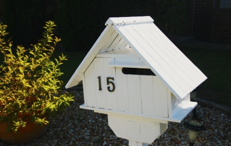 Wooden white mailbox in a house gardenの写真素材