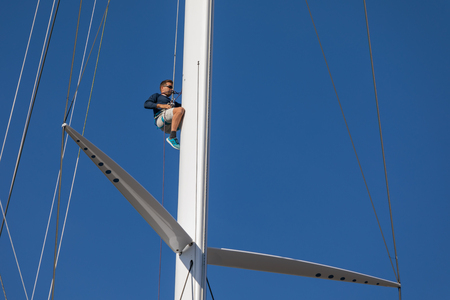 05 OCT 2019 - Saint-Tropez, Var, France - A man climbing a mast during the 2019 edition of 'Les Voiles de Saint-Tropez' regattaのeditorial素材