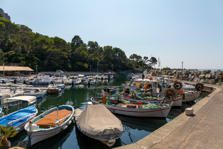 03 SEP 2019 - Saint-Raphael, Var, France - Fishermen fixing nets in Poussai Harbor in Le Dramontのeditorial素材