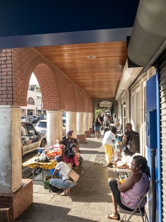 10 JAN 2020 - Kingstown, Saint Vincent and the Grenadines - Street vendors under the archs of Kingstownのeditorial素材