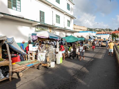 10 JAN 2020 - Kingstown, Saint Vincent and the Grenadines - Market vendors in the streetのeditorial素材