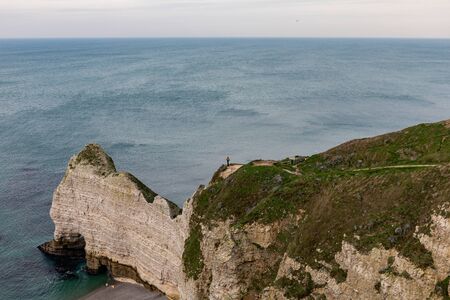 Etretat, Normandy, France - A man standing at the top of the nortern cliff ('Amont' cliff)の写真素材