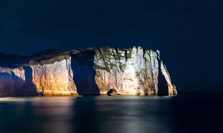 Etretat, Normandy, France - The cliffs at the south ('Aval' cliff) with its natural arch, by nightの写真素材