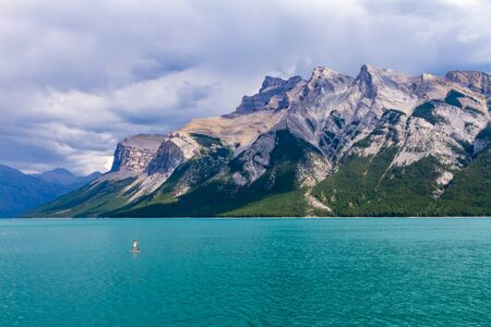 Stand Up Paddle in Lake Minnewanka - Banff National Park, Banff, Alberta, Canadaの写真素材