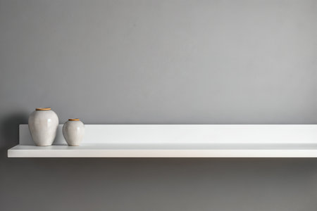Ceramic vases on white shelf against grey wall. Interior designの素材