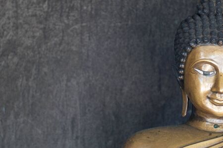half face of Lord Buddha image with gray backgroundの写真素材