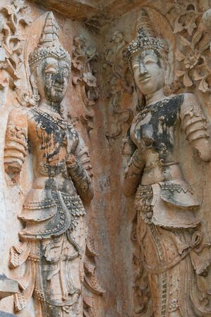 Fairy stucco on a wall of a buddhist temple in thailandの写真素材
