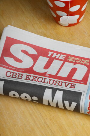 Bracknell, United Kingdom - January 11, 2014  A rolled up copy of The Sun Newspaper  The Sun is a daily newspaper in the UK in circulation since 1964 and is part of the media group News UK のeditorial素材