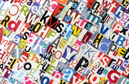 cut out magazine letters pasted to a board with random letters の写真素材