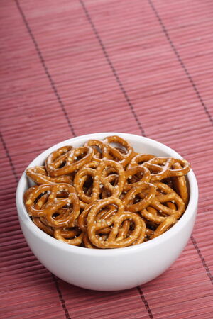 Salted Pretzel snacks in a white bowlの写真素材