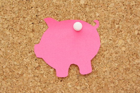 Piggy Bank post it note pinned to a cork background as a reminder to save moneyの写真素材