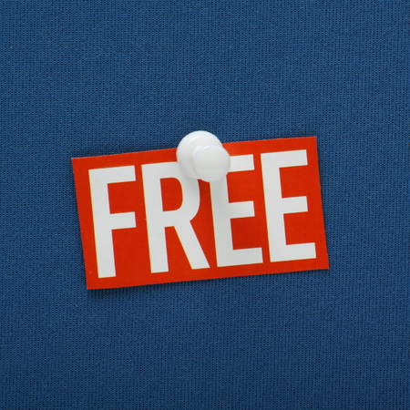 The word Free in red and white pinned to a blue notice boardの写真素材
