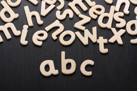 Wooden letters arranged to spell abc for the alphabet on a blackboard