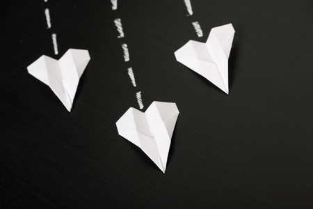 Paper Planes fly in formation across a blackboard surface