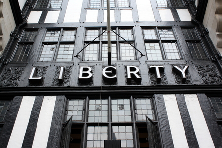 London, England - Sept 4th, 2014: The sign above the entrance to the Liberty department store in Regent Street, London. Opened in 1875 the store is identified with luxury goods and classic designs.のeditorial素材