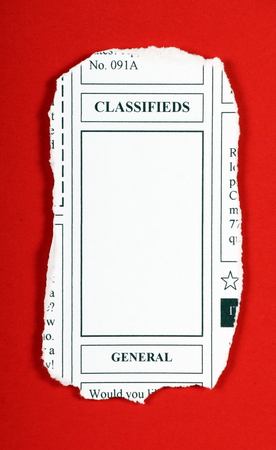 A mock up of a classified advertising newspaper clipping with copy space for your text on a red backgroundの写真素材