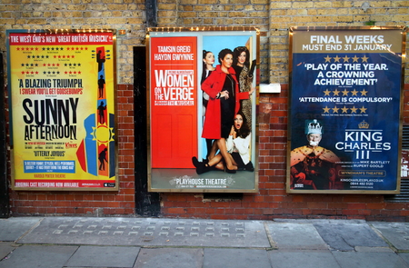 London, England - January 24, 2015: Billboard posters on a brick wall advertising musicals and plays in the West End of London. In 2013, ticket sales for London theatres were in excess of 500mのeditorial素材