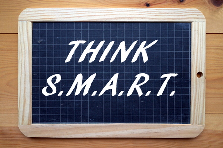 The words Think SMART on a blackboard. The business acronym for project planning and change management that stands for Specific, Measurable,Achievable, Relevant and Time-boundの写真素材