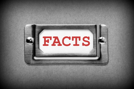 The word Facts in red text on a filing cabinet drawer label, processed in black and white for effectの写真素材