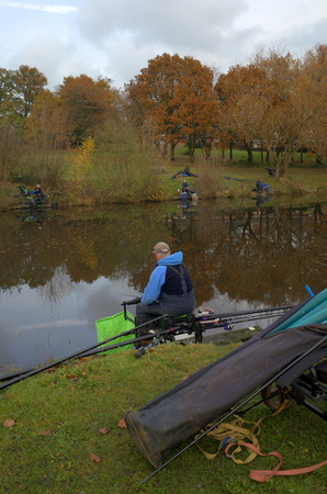 Bracknell,England - November 23, 2016: People fishing with rod and reel on the banks of a public lake on a cloudy November day in Bracknell, Englandのeditorial素材