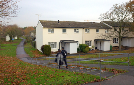 Bracknell,England - December 09, 2016: Pedestrians walking down steps in front of a row of houses on a housing estate in Bracknell, England on a cloudy, December dayのeditorial素材