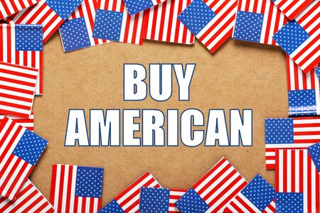 The words Buy American surrounded by flags of the United States of America as a reminder to buy their products and servicesの写真素材