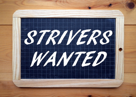 The words Strivers Wanted in white text on a blackboardの写真素材