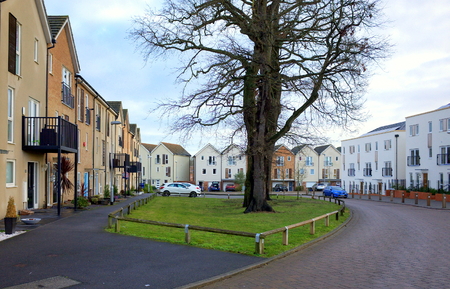 Bracknell,England - January 22, 2018: Wide angle view of modern homes and fully grown trees on a road through a housing estate in Bracknell, Englandのeditorial素材