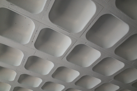 The molded concrete ceiling of a car park photographed to provided an abstract backgroundの写真素材