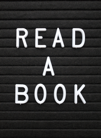 The words Read A Book in white plastic letters on a black letter boardの写真素材