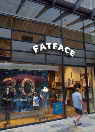 Bracknell, England - May 30, 2018: A pedestrian passes by the Fat Face clothing store in Bracknell, England. Fat Face is a lifestyle clothing and accessories retailer based in the UKのeditorial素材