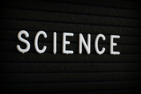 The word Science in white plastic letters on a black letter boardの写真素材