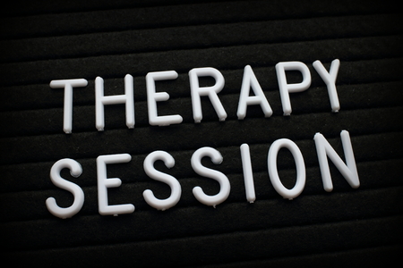 The words Therapy Session in white plastic letters on a felt notice boardの写真素材
