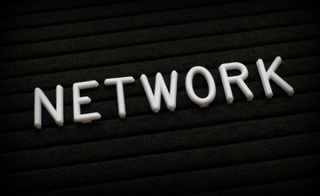 The word Network in white plastic letters on a black letter boardの写真素材
