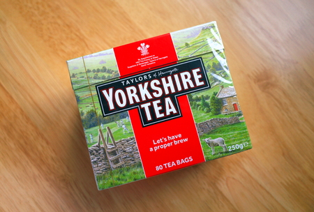 Bracknell, England - April 03, 2019: Unopened box of Yorkshire Tea bags on a wooden table top. Taylors of Harrogate have been providing tea in England since 1886のeditorial素材