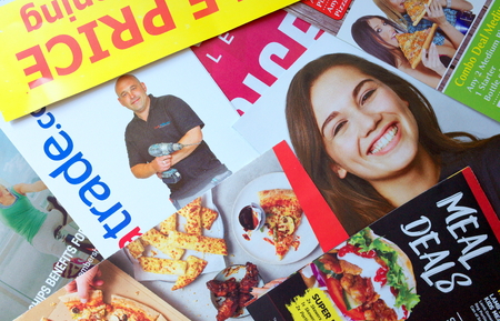 Bracknell, England - April 10, 2019: Sample of leaflets and brochures or Junk Mail delivered to a private address in Bracknell, England to advertise local retail and service businessesのeditorial素材