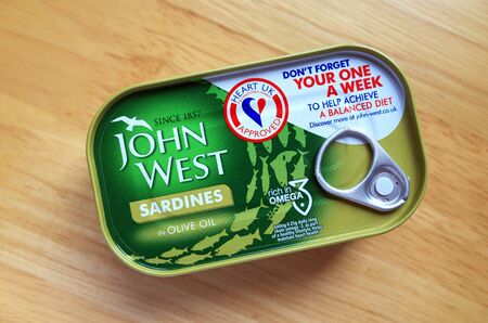 BRACKNELL, ENGLAND - FEBRUARY 03, 2020: A tin of John West branded sardines in olive oil bearing  the Heart UK charity approval logoのeditorial素材