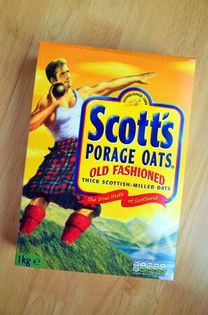Bracknell, England - February 6th, 2020: A box of Scott's Old Fashioned Porridge Oats on a wooden table. The company was started by A & R Scott in 1880 in Glasgow, Scotlandのeditorial素材