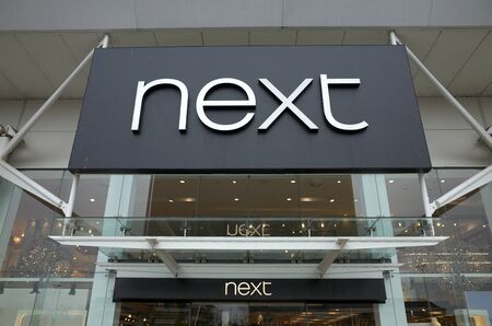 Bracknell, England - February 19, 2020: Sign above the Next retail Store in Bracknell, England. Next plc, is a British multinational clothing, footwear and home products retailerのeditorial素材