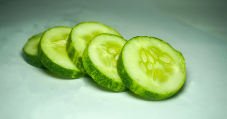 sliced cucumber on white background. preparing salad with cucumber.の写真素材