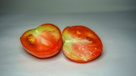 sliced healthy tomato on white. Healthy food for human body.の写真素材