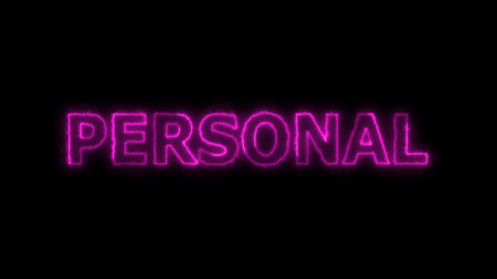 Neon sign with the word PERSONAL in pink on a dark background.の写真素材