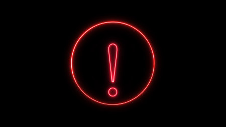 Neon red exclamation mark glowing on a dark background.の写真素材