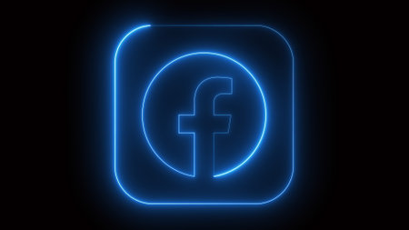A glowing neon blue Facebook logo on a black background. The logo is encased in a rounded square with a bright outline.の写真素材