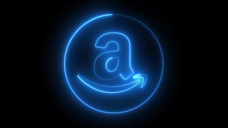 A glowing blue neon Amazon logo on a black background. The logo consists of a lowercase 'a' with a curved arrow underneath, forming a smile.の写真素材