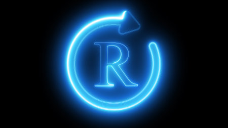 A glowing blue neon registered trademark symbol on a black background.の写真素材
