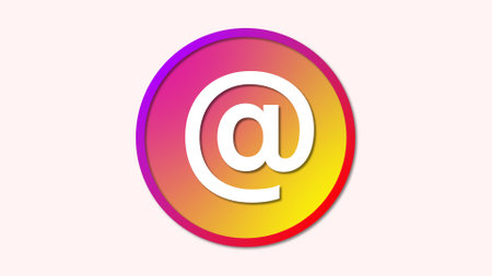 A colorful gradient circle with an '@' symbol in the center, representing email or social media contact.の写真素材