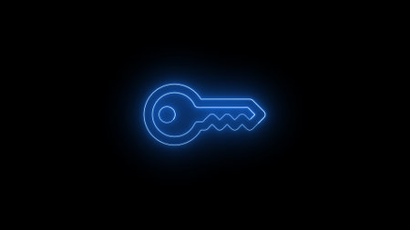 A glowing neon key icon on a black background.の写真素材
