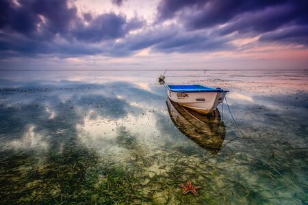 ship and starfish on the beach with reflection sunrise skyのeditorial素材